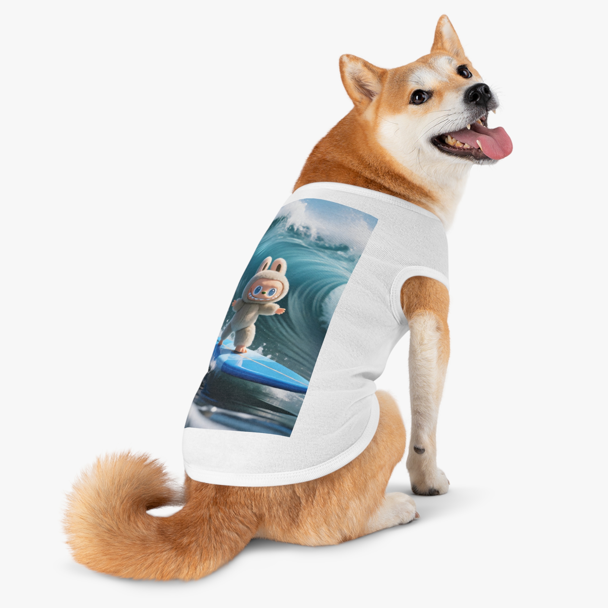 A playful dog wearing a surfing bunny tank top featuring a colorful surfboard design