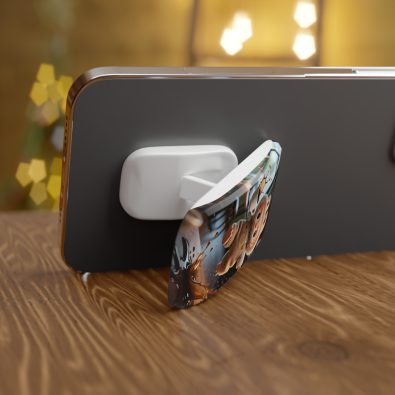 A quirky phone grip that looks like a clumsy monster holding a coffee cup, with a click-on design for easy attachment to smartphones