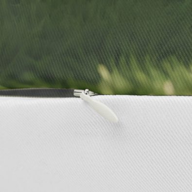 A soft, plush soccer-themed pillow featuring a smiling ball and green field design, perfect for kids' rooms